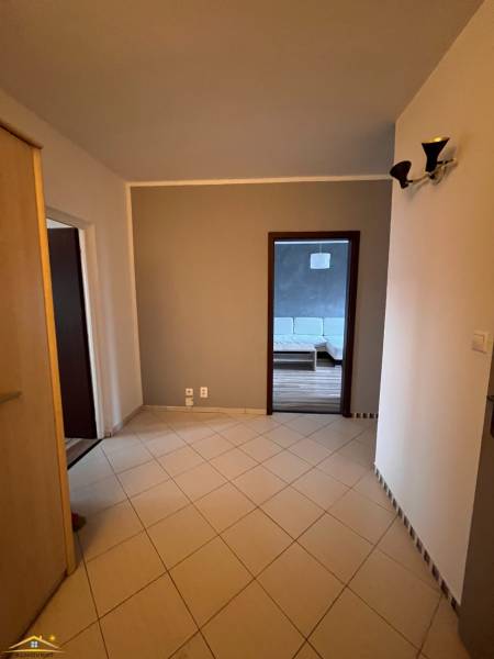 Előszoba egy 2 szobás lakásban, kilátással a fa mintázatú padlóra.