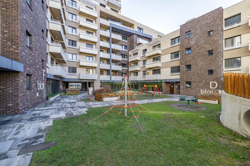 A lakókomplex udvara játszótérrel a Na križovatkách utcában, Pozsony - Ružinov.