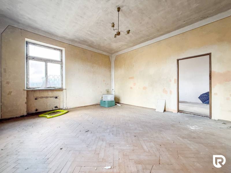 Szoba egy családi házban, fa dekorációjú padlóval és egyszerű világítással.