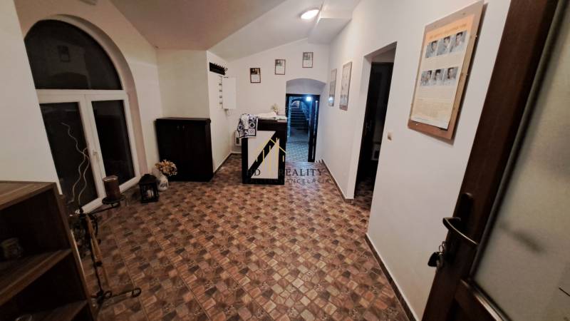 Vendéglátóhely belső terei fa mintázatú padlóval, világos színű falakkal díszítve.