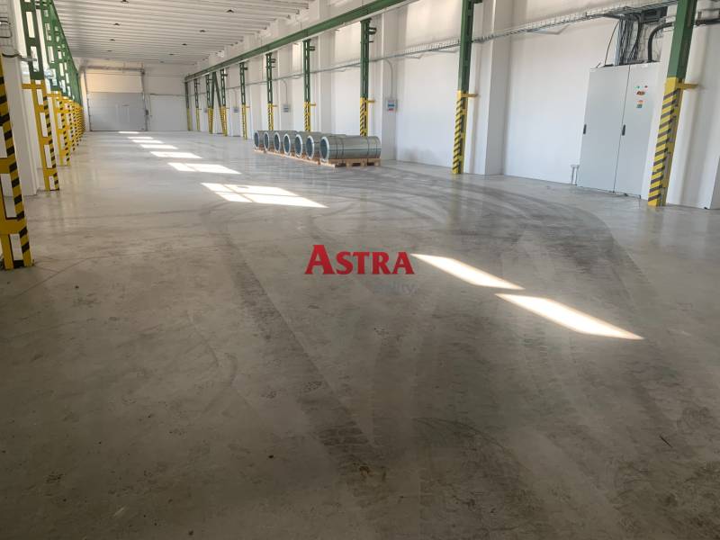 Tágas belső tér raktárhelyiségekkel és acélhordókkal, raktárak és csarnokok.