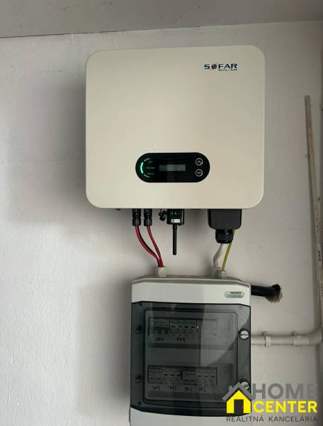 SOFAR márkájú napelemes inverter felszerelve egy családi ház falára.