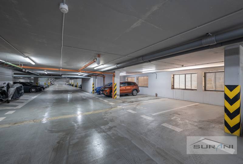 Földalatti parkoló kijelölt parkolóhelyekkel és parkoló autókkal és motorokkal.