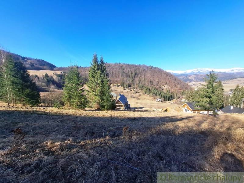Mezőgazdasági és erdészeti területek Hroncban, dombokkal és tűlevelű fákkal körülvéve.