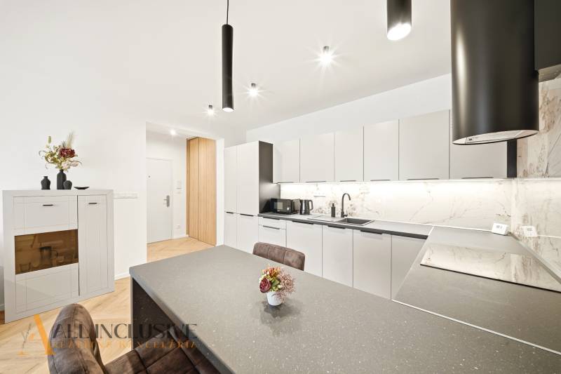 Konyha egy 4 szobás lakásban, finom dekorációval a falakon és lágy színekkel.