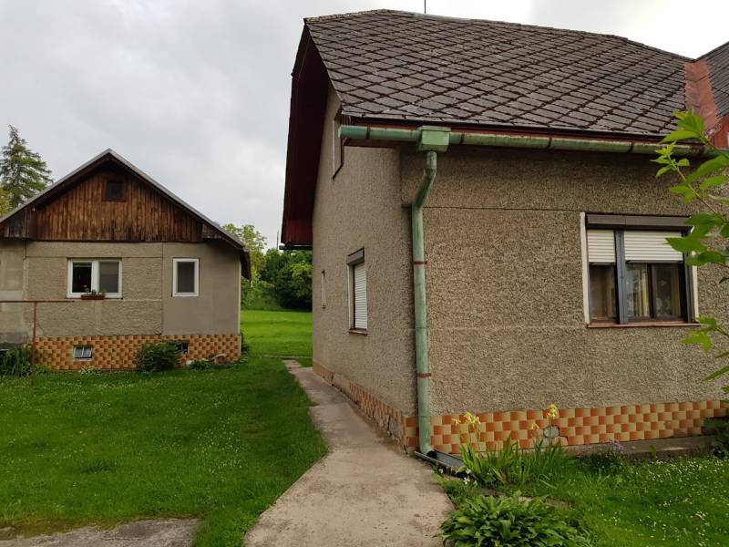 Családi ház Blatnicán, Blatnica utcában, két épülettel és zöld gyepes udvarral.