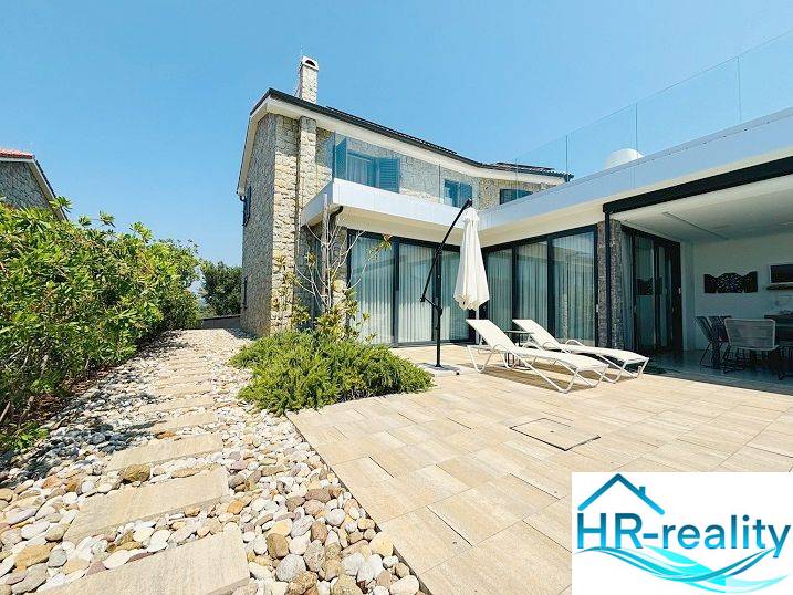 Villa Jakišnicában terasszal, köves ösvénnyel és pihenő nyugágyakkal.