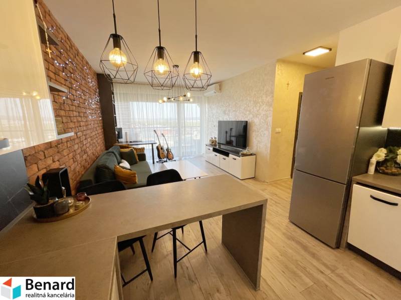 Nappali bárpulttal, fa hatású padlóval és téglás akcentussal.