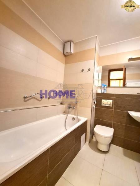 Fürdőszoba káddal, piszoárral és mosdóval egy kétszobás lakásban.