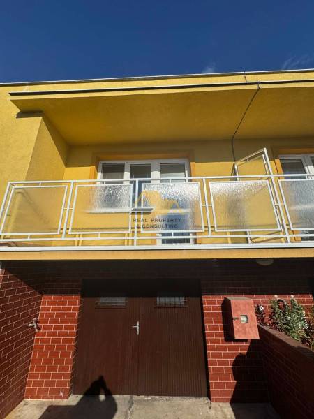 Családi ház Érsekújváron, az Érsekújvári utcában, erkéllyel és téglaburkolattal.