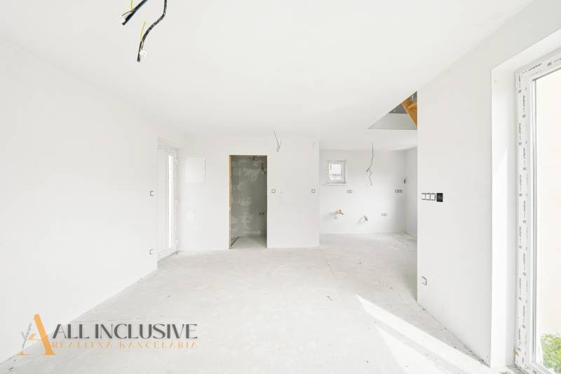 A kunyhó belseje fehér falakkal és befejezetlen padlóval, előkészítés a telepítésekhez.