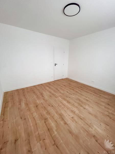 Üres szoba világos falakkal és fa dekorációjú padlóval, 3 szobás lakás.