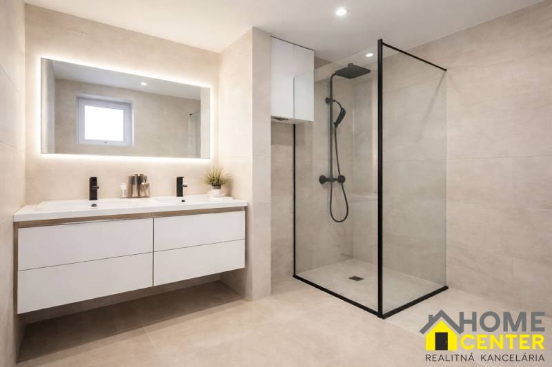 Fürdőszoba nagy tükörrel és zuhanyzóval egy családi házban.