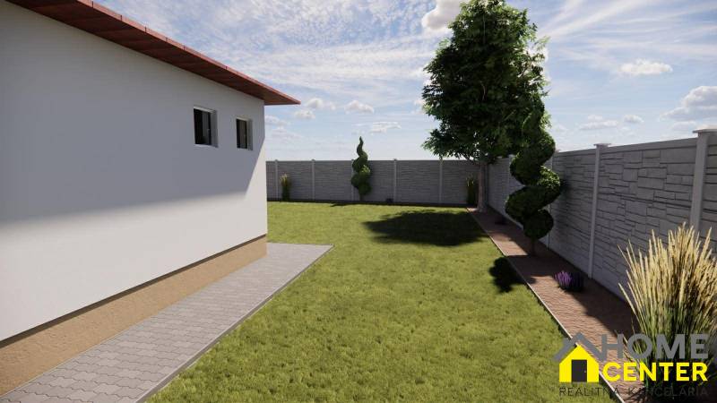 Családi ház kertje Zemianska Olčában gyepes és díszcserjékkel, kerítéssel körülvéve.