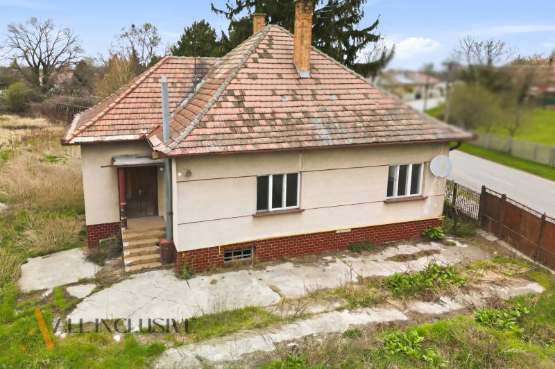 Családi ház Mihályfán ferde tetővel és műholdas antennával.