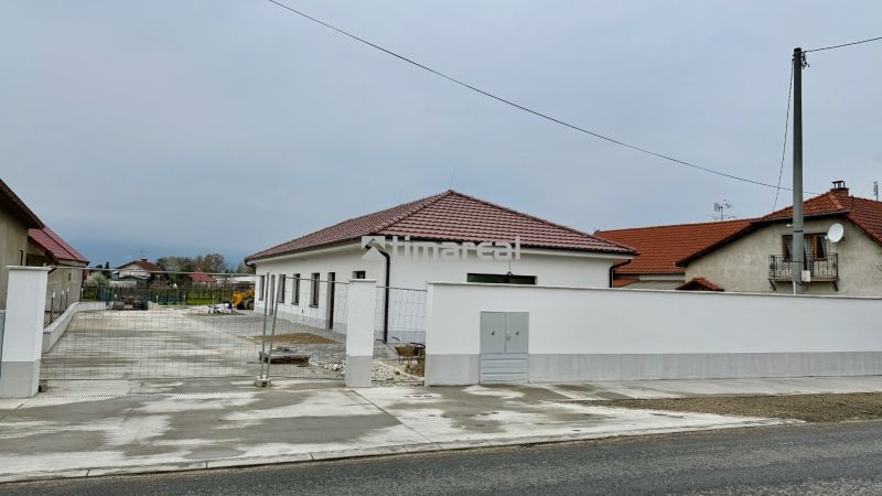 Családi ház a Fő utcában, Vlčanyban, fehér homlokzat, piros tető.