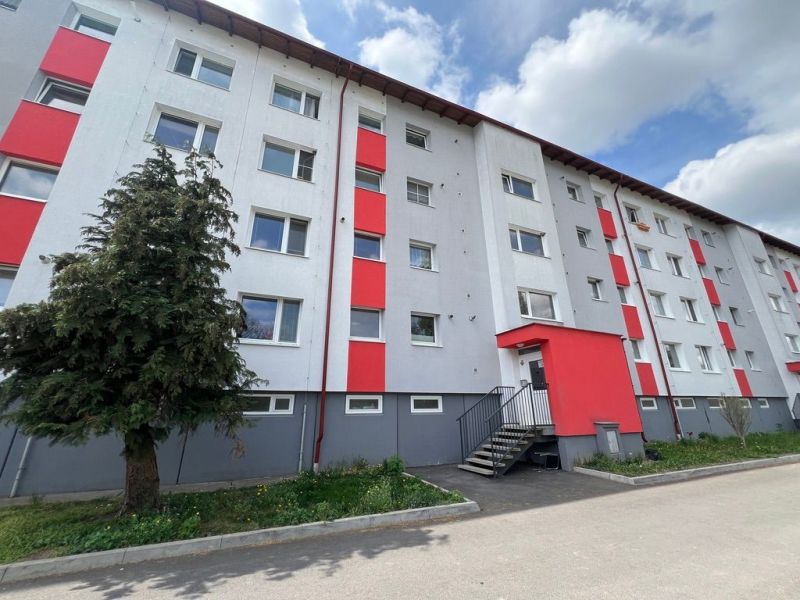 Lakóház a Za Nožiarňou utcában, Slovenská Ľupča, feltűnő piros panelekkel.