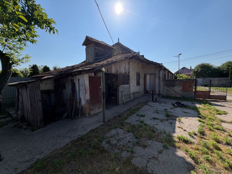 Családi ház Nesvadban sérült tetővel és napos udvarral.