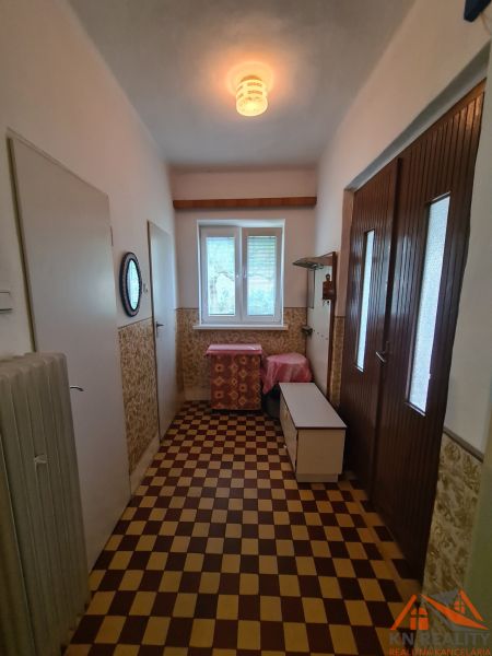 Csempefolyosó családi házban, fényforrás, tárolóhely, radiátor.