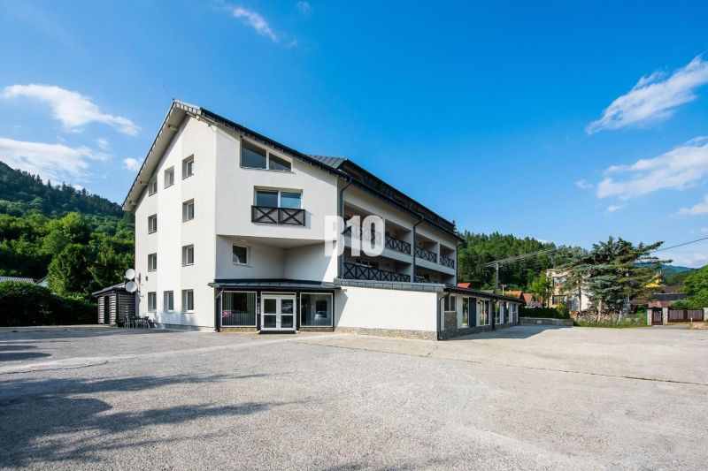 A teraszos apartman külseje Terchovában, tiszta égbolttal és körülötte zöldellő növényzettel.
