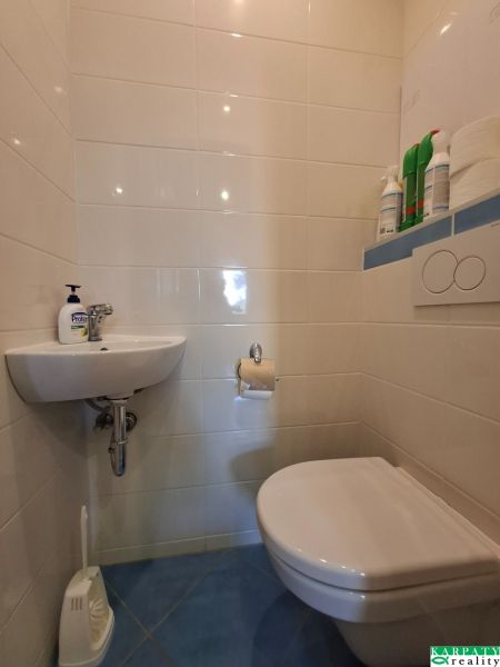 A 3 szobás lakás WC-je mosdóval világos csempével rendelkezik.