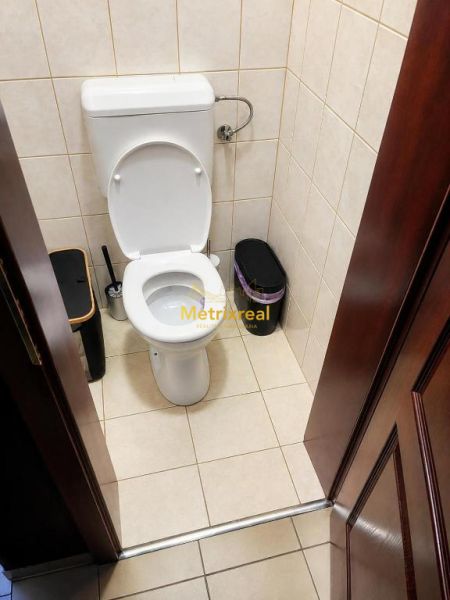 WC fehér kerámia csészével és csempével egy családi házban.