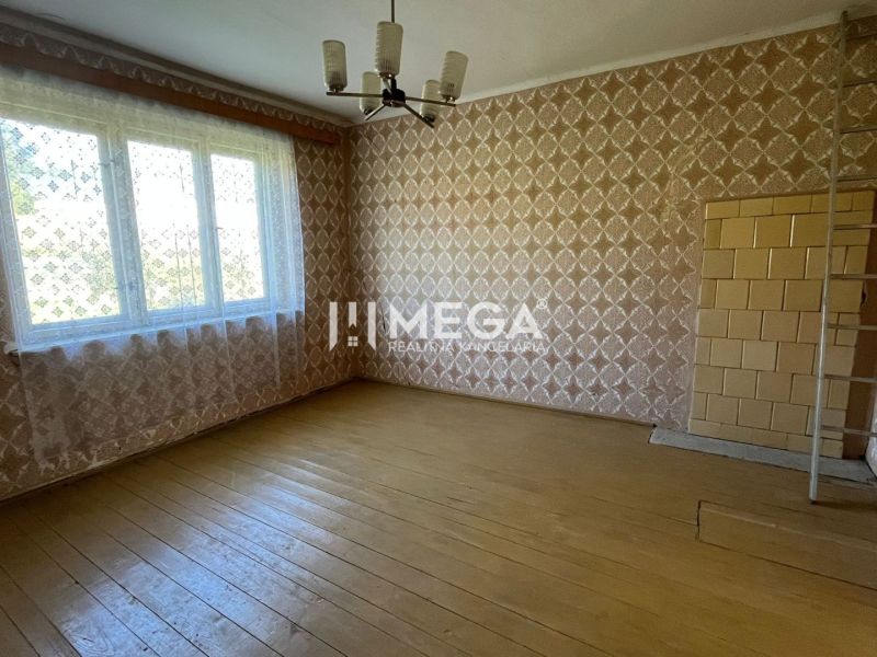 Családi ház fa mintázatú padlóval, mintás tapétákkal és nagy ablakkal.