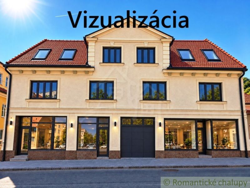 Az üzlethelyiségekkel rendelkező épület homlokzata Kékkő városában, amely üveg kirakatokat ábrázol.